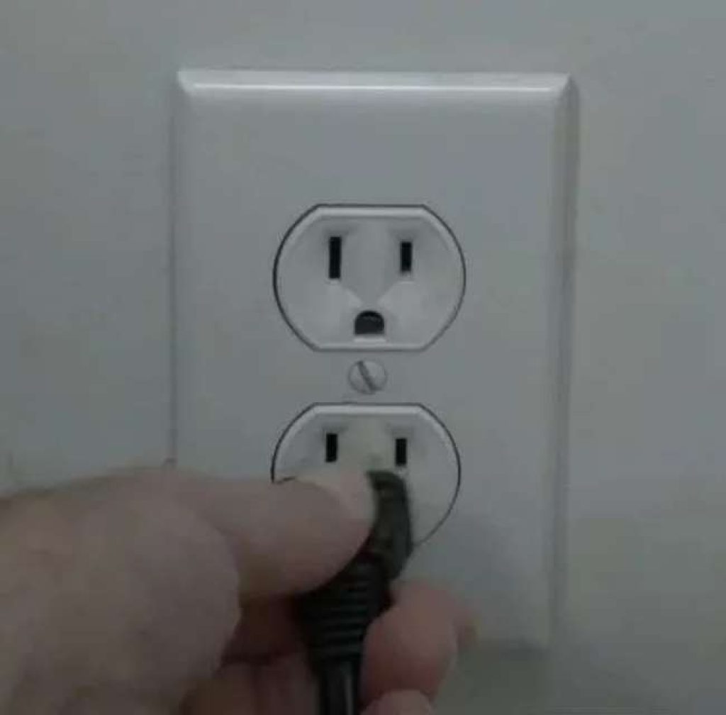 Unplugging-the-TV-plug-from-the-power-wall-socket